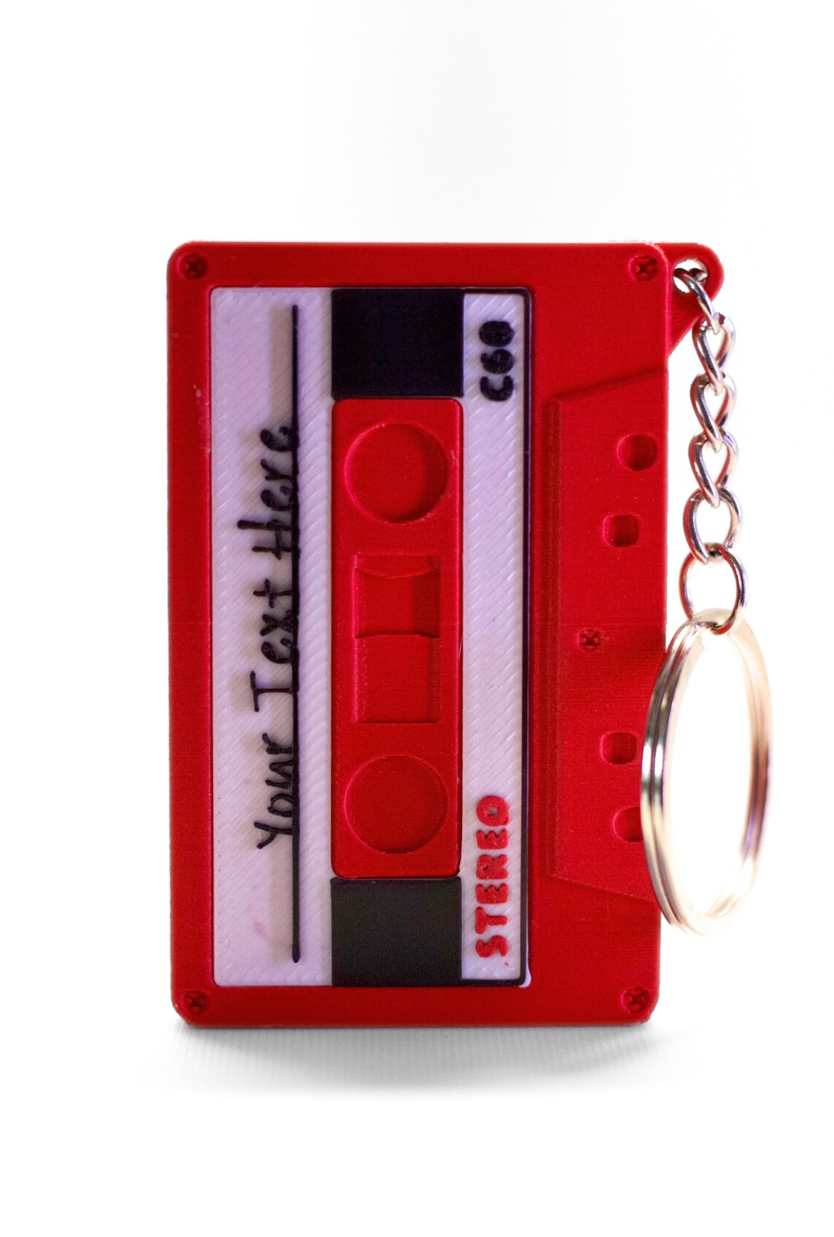 Image of a red cassette keychain, with a white and black label with the label text reading "Your Text Here"