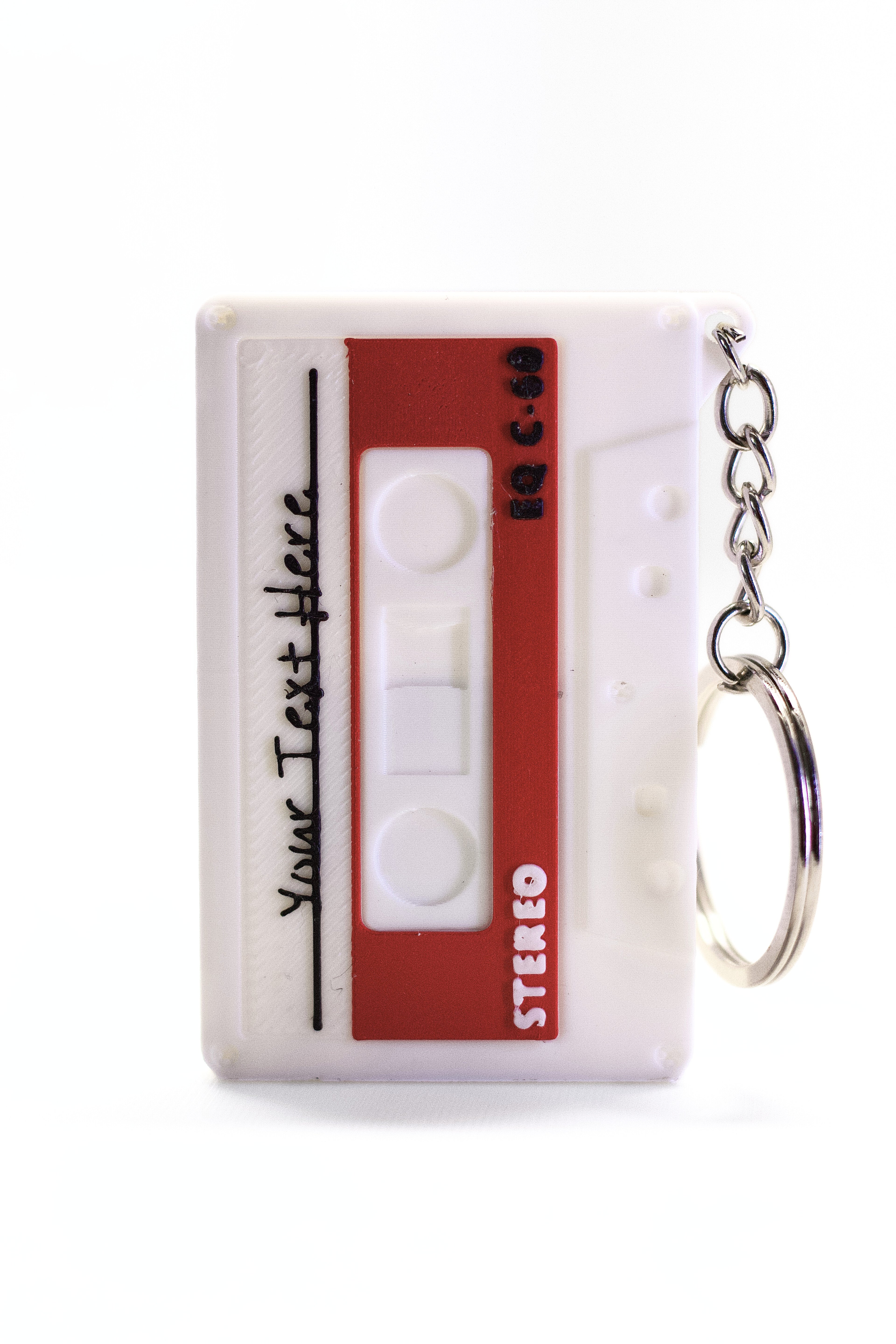 Cassette tape-shaped keychain with a key ring on a white background